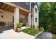 Charming brick home featuring a covered patio with wood ceiling and lovely garden at 1428 Spring Ridge Ln, Denver, NC 28037