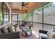 Covered back porch with wicker furniture, ceiling fan, brick columns, and room for outdoor dining at 1428 Spring Ridge Ln, Denver, NC 28037