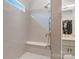Walk-in shower featuring a built-in bench seat, rain shower head, and a window for natural light at 1428 Spring Ridge Ln, Denver, NC 28037