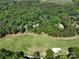 Aerial view of property including homes, golf course, and wooded area at 154 Patterson'S Bridge None, New London, NC 28127