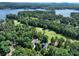 Aerial view of property including home, golf course, and lake at 154 Patterson'S Bridge None, New London, NC 28127