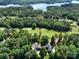 Stunning aerial view of a lakeside property with a lush golf course nearby surrounded by mature trees at 154 Patterson'S Bridge None, New London, NC 28127