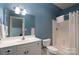 A full bathroom featuring a shower and tub, a sink with storage, a toilet, and blue paint at 154 Patterson'S Bridge None, New London, NC 28127