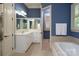 Primary bathroom with double sinks, soaking tub, and lots of natural light at 154 Patterson'S Bridge None, New London, NC 28127
