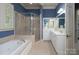 The bathroom is enhanced with a glass walk-in shower, a soaking tub, and double mirrors over a vanity at 154 Patterson'S Bridge None, New London, NC 28127