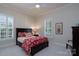 Comfortable bedroom featuring a dark wood bed with red patterned bedding and bright natural light at 154 Patterson'S Bridge None, New London, NC 28127