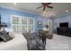 Spacious primary bedroom with neutral carpet, sitting area, and plantation shutters at 154 Patterson'S Bridge None, New London, NC 28127