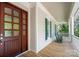 Inviting front porch with wood flooring, rocking chairs, and a beautiful wood front door at 154 Patterson'S Bridge None, New London, NC 28127