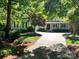 Well-maintained home featuring a landscaped front yard, a long driveway, and mature shade trees at 154 Patterson'S Bridge None, New London, NC 28127