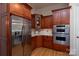 Bright kitchen boasts stainless steel appliances, tile backsplash, and cherry wood cabinetry at 154 Patterson'S Bridge None, New London, NC 28127