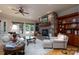 Cozy living room with stone fireplace, built-in shelving, plush seating, and a ceiling fan at 154 Patterson'S Bridge None, New London, NC 28127