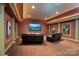 An entertainment room with theater style seating, wall decor and a large tv at 154 Patterson'S Bridge None, New London, NC 28127