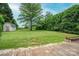 Spacious backyard featuring a large lawn, a storage shed, and a wooden deck at 1774 Smyrna Ln, Catawba, NC 28609