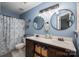 Stylish bathroom with a double sink vanity, modern lighting, and a shower with a patterned curtain at 1774 Smyrna Ln, Catawba, NC 28609