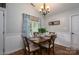 Bright dining room featuring a wooden table with seating for four and a window with patterned curtains at 1774 Smyrna Ln, Catawba, NC 28609