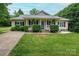 Charming ranch-style home with a welcoming front porch, lush landscaping and a well-manicured lawn at 1774 Smyrna Ln, Catawba, NC 28609
