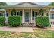 Inviting front porch with stone accents, manicured bushes, and a blue front door with glass detail at 1774 Smyrna Ln, Catawba, NC 28609