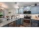Stylish kitchen with blue cabinets, stainless steel appliances, granite countertops, and white subway tile backsplash at 1774 Smyrna Ln, Catawba, NC 28609
