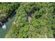 Aerial view of a lakeside home surrounded by mature trees, providing privacy at 188 Stonemarker Rd, Mooresville, NC 28117