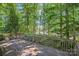 Wooden back deck with scenic views of lush greenery and a glimpse of the water, perfect for relaxing at 188 Stonemarker Rd, Mooresville, NC 28117