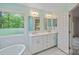Bright bathroom with double sinks, white cabinets, and a large window at 188 Stonemarker Rd, Mooresville, NC 28117