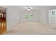 Spacious bedroom with ample natural light, plush carpet, and a closet at 188 Stonemarker Rd, Mooresville, NC 28117