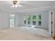 Bright bedroom with carpet, exterior access, and an ensuite bathroom at 188 Stonemarker Rd, Mooresville, NC 28117
