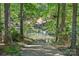 View of a private boat ramp leading to the lake, surrounded by lush greenery at 188 Stonemarker Rd, Mooresville, NC 28117