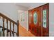 Welcoming front foyer with a decorative wood door with glass and staircase at 188 Stonemarker Rd, Mooresville, NC 28117