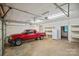 Spacious garage with a red truck, shelving, and ample storage at 188 Stonemarker Rd, Mooresville, NC 28117