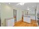 Well-lit kitchen with granite countertops, light green walls, stainless appliances, and hardwood floors at 188 Stonemarker Rd, Mooresville, NC 28117