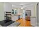 Modern kitchen featuring stainless steel appliances, granite countertops and hardwood floors at 188 Stonemarker Rd, Mooresville, NC 28117