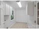Bright laundry room with built-in cabinets and tile flooring at 188 Stonemarker Rd, Mooresville, NC 28117