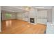 Bright living room featuring hardwood floors, a cozy fireplace, and built-in shelving and cabinets at 188 Stonemarker Rd, Mooresville, NC 28117