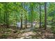 Scenic stone path leading to a private dock on the lake, nestled among mature trees at 188 Stonemarker Rd, Mooresville, NC 28117