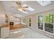 Bright sun room featuring a fireplace, hardwood floors, tile floors, and abundant natural light at 188 Stonemarker Rd, Mooresville, NC 28117