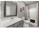 Elegant bathroom with gray vanity, decorative patterned floors, and a shower-tub combination at 1918 Thoreau Way, York, SC 29745