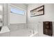 Relaxing bathroom with a soaking tub, marble tile surround, and decorative towel rack at 1918 Thoreau Way, York, SC 29745