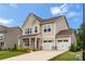 Inviting two-story home with a two-car garage and lush green lawn at 1918 Thoreau Way, York, SC 29745