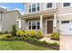 Charming front porch with stone accents and lush landscaping at 1918 Thoreau Way, York, SC 29745
