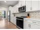This kitchen has stainless steel appliances and white cabinetry, offering a sleek, modern space for culinary endeavors at 1918 Thoreau Way, York, SC 29745