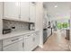 Bright kitchen features stainless steel appliances, white cabinetry, and a decorative backsplash, perfect for modern living at 1918 Thoreau Way, York, SC 29745