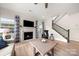 Inviting living room with a fireplace, staircase, and hardwood floors, creating a warm and comfortable atmosphere at 1918 Thoreau Way, York, SC 29745