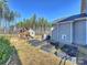 Backyard with playhouse, shed, and garden beds, perfect for outdoor activities and gardening enthusiasts at 2025 Sweet Magnolia Ln, Clover, SC 29710