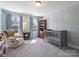 Bedroom with a gray crib, blue accents, and plenty of natural light at 2025 Sweet Magnolia Ln, Clover, SC 29710