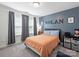 Bedroom with a twin bed, carpet, and a calming blue accent wall at 2025 Sweet Magnolia Ln, Clover, SC 29710