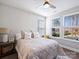 Well-lit bedroom with a queen-size bed and windows overlooking the backyard at 2025 Sweet Magnolia Ln, Clover, SC 29710
