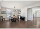Bright dining room with hardwood floors, modern chandelier, and space for entertaining at 2025 Sweet Magnolia Ln, Clover, SC 29710