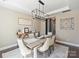 Beautiful dining room with a farmhouse-style table and sophisticated chandelier lighting at 2025 Sweet Magnolia Ln, Clover, SC 29710