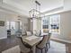 Bright dining room with a contemporary chandelier and expansive view to a home office at 2025 Sweet Magnolia Ln, Clover, SC 29710